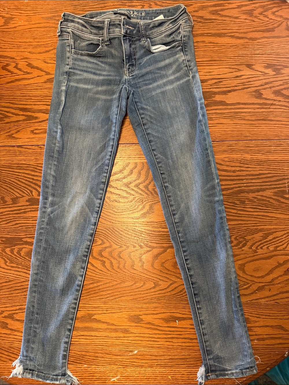 American Eagle Outfitters Faded Blue Skinny Jeans with Frayed Hem